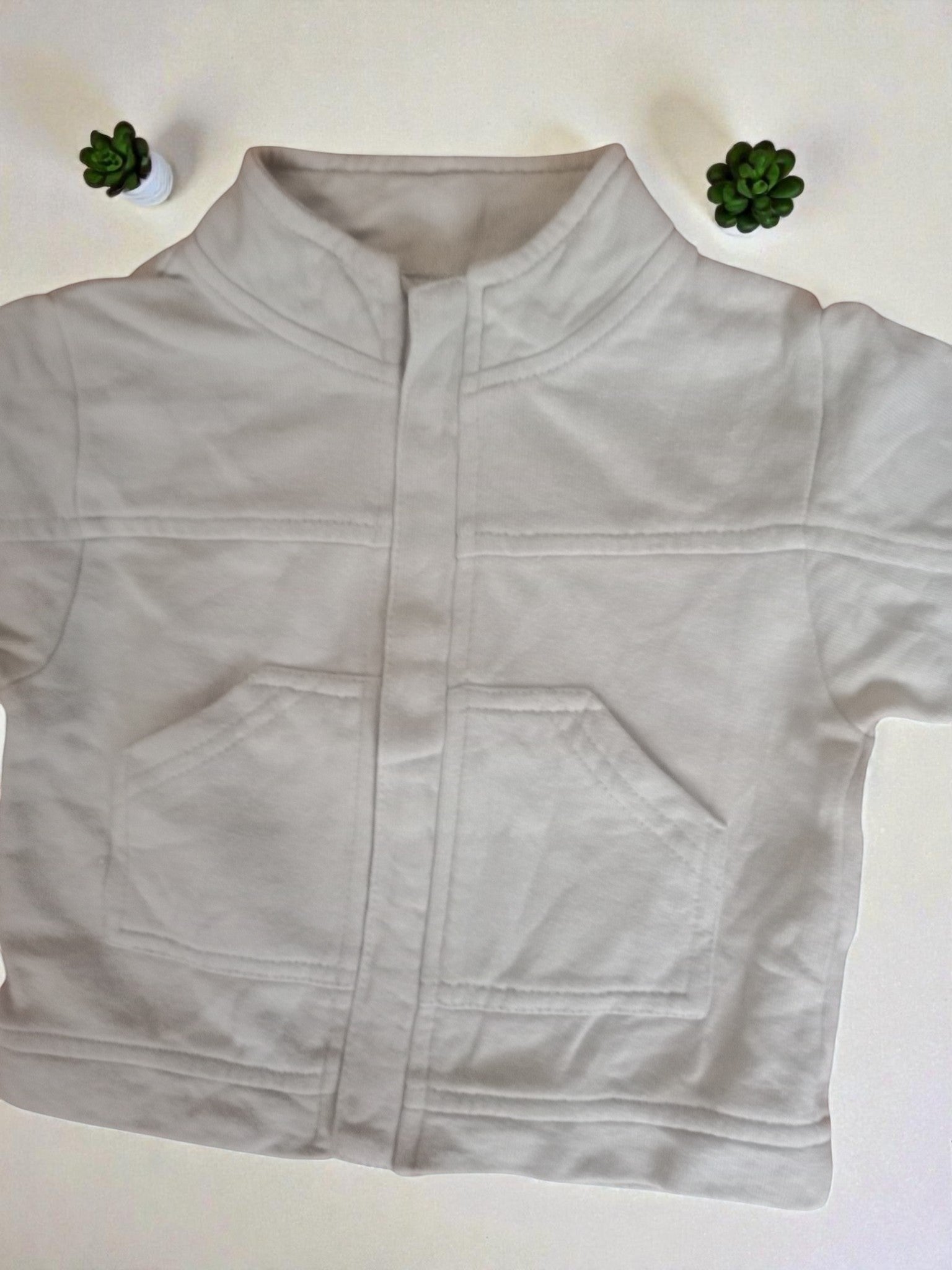 Jeans And Jackets light grey zip-up fleece sweatshirt with two chest pockets and a stand-up collar.